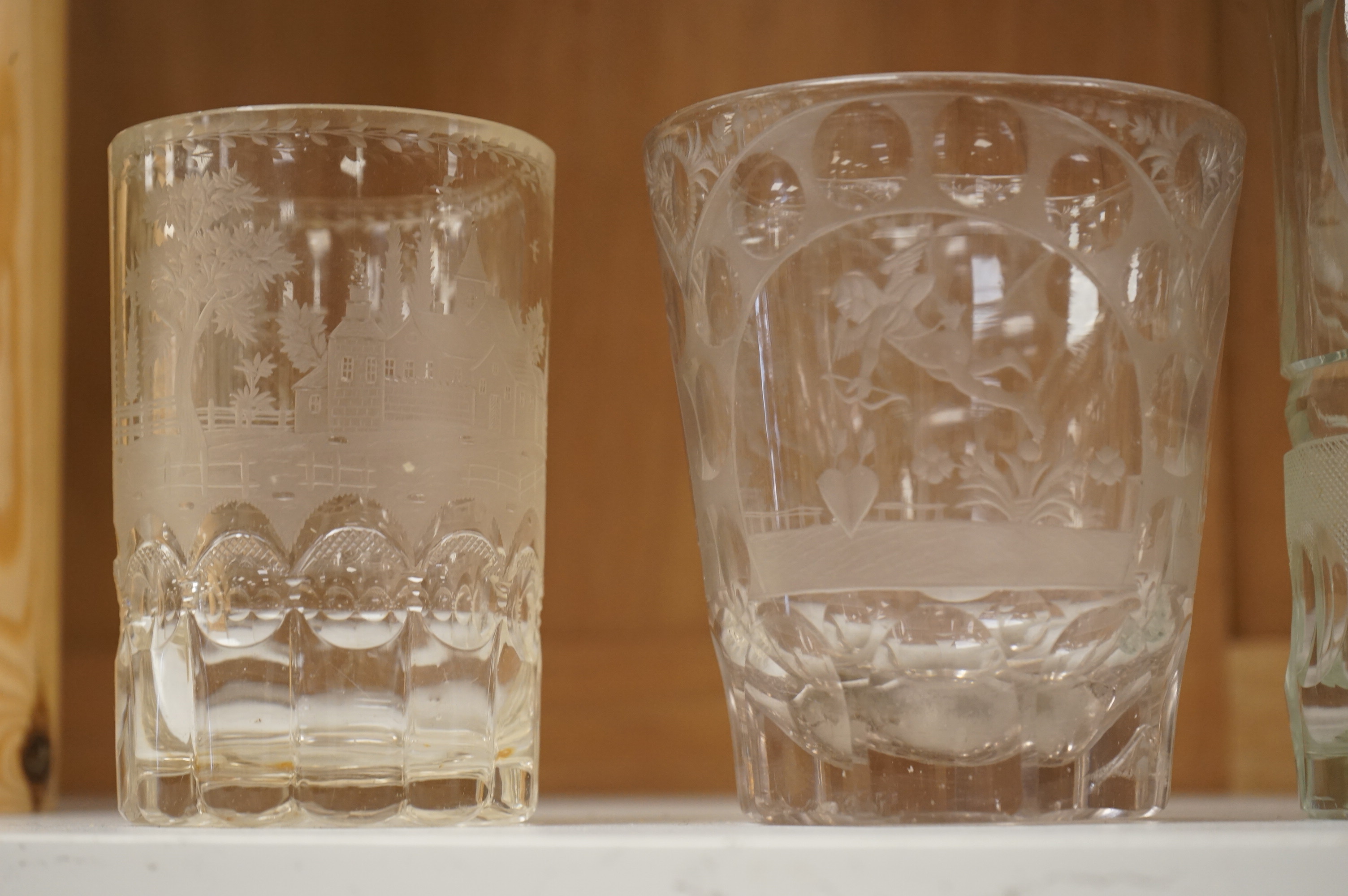 Four German or Bohemian engraved glass beakers, 19th century, largest 16cm high